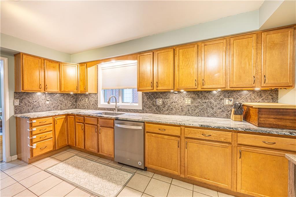 63 Evergreen Terrace Uniontown, PA 15401 - Photo 16 of 25 a kitchen with granite countertop sink cabinets and window