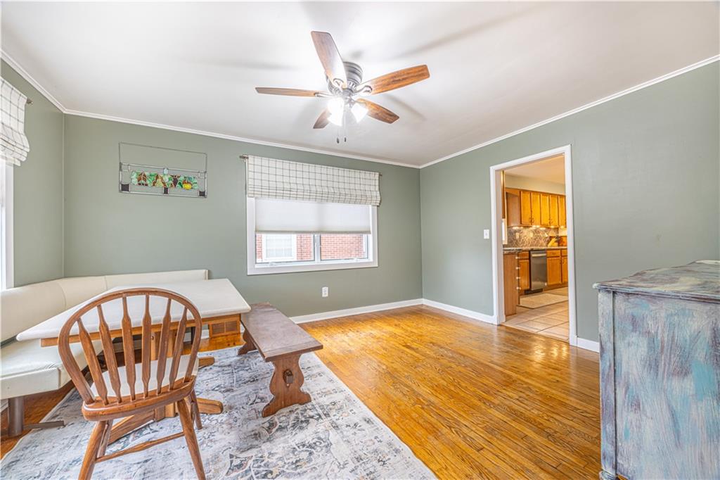63 Evergreen Terrace Uniontown, PA 15401 - Photo 10 of 25 a view of a livingroom with wooden floor and a ceiling fan