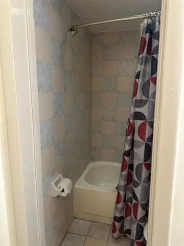 a bathroom with a bathtub and a shower