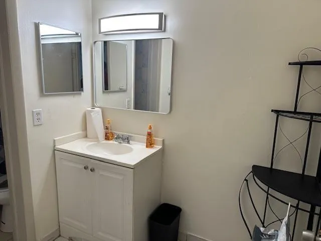 a bathroom with a sink toilet and mirror