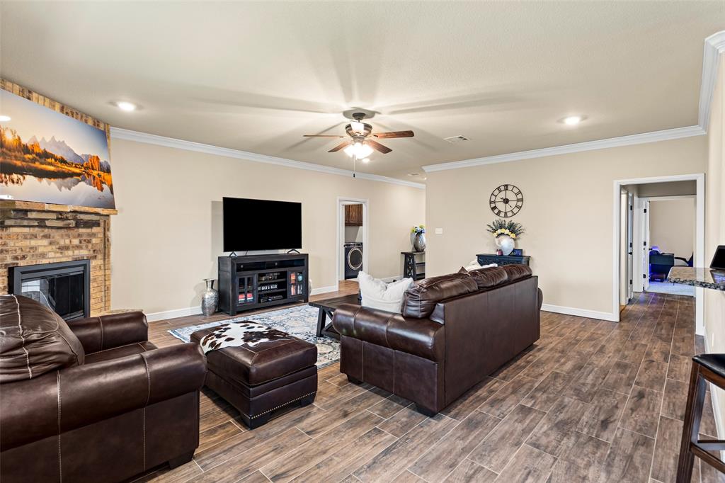 223 Cottongame Road Weatherford, TX 76088 - Photo 10 of 39 a living room with furniture and a flat screen tv