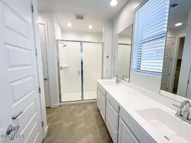 a bathroom with a double vanity sink mirror and double