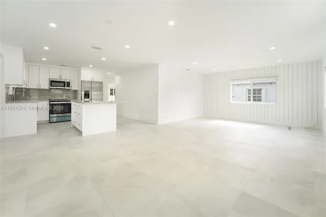 a view of a kitchen with refrigerator and microwave