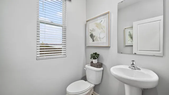 a bathroom with a sink toilet and mirror