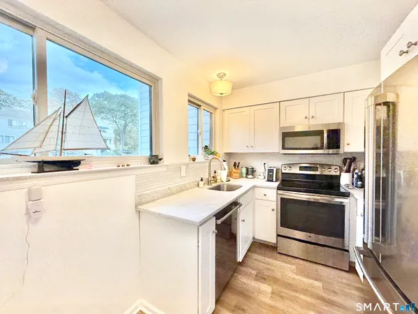 a kitchen with a sink stove and microwave