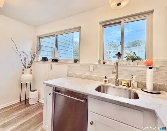 a kitchen with a sink cabinets and a large window