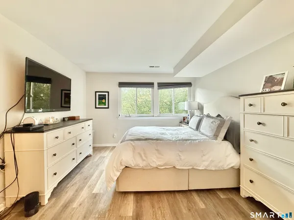 a bedroom with a large bed and a dresser