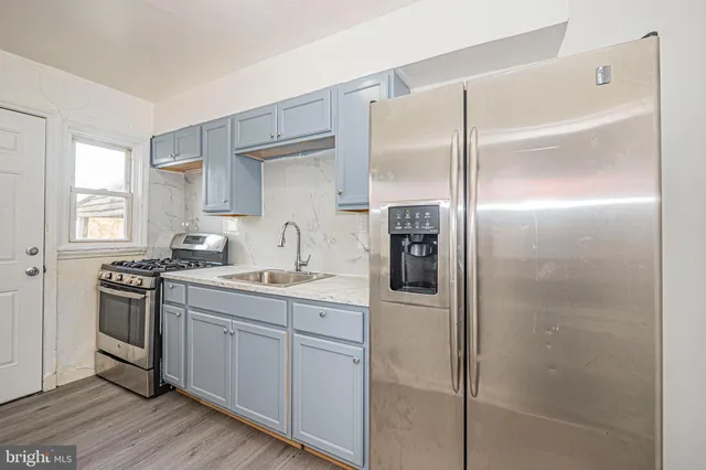 a kitchen with a sink appliances and cabinets