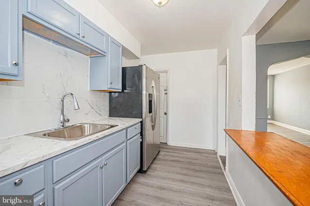 a spacious bathroom with a sink and a large mirror