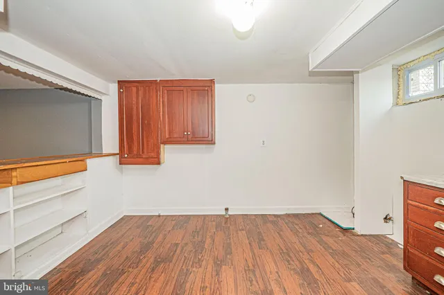 a view of a room with wooden floor and cabinet