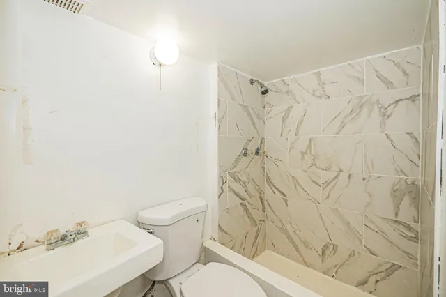 a white toilet sitting next to a bathroom sink