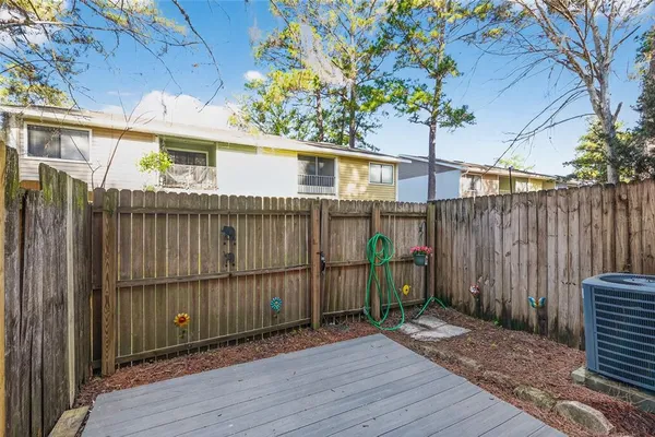 a view of a house with a small yard and wooden floor