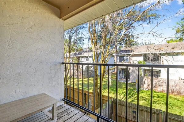 a view of a balcony with wooden floor