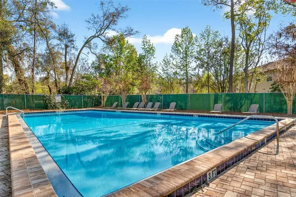 a view of a swimming pool with a patio