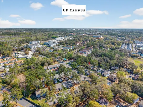 an aerial view of residential building with green space