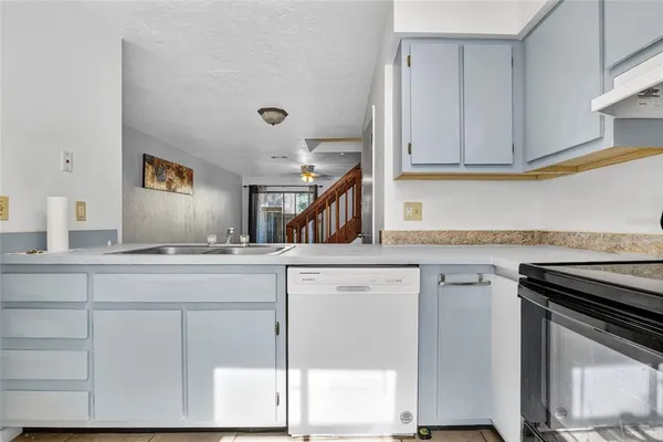 a kitchen with cabinets appliances a sink and a counter top space