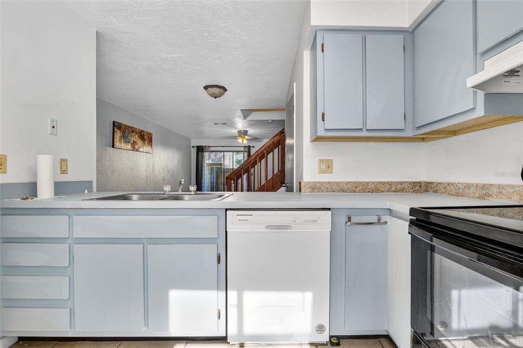 2116 Southwest 39 Drive Gainesville, FL 32607 - Photo 5 of 28 a kitchen with cabinets appliances a sink and a counter top space