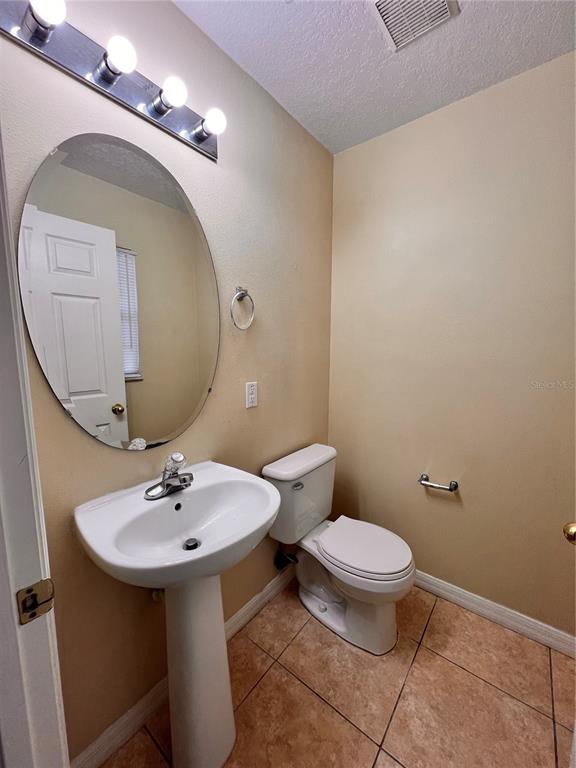 2476 Hassonite Street Kissimmee, FL 34744 - Photo 4 of 8 a bathroom with a sink and mirror