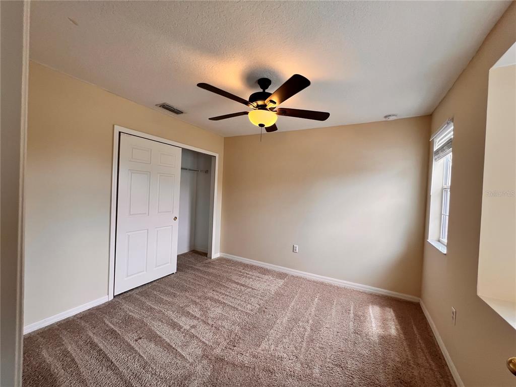 2476 Hassonite Street Kissimmee, FL 34744 - Photo 6 of 8 a view of an empty room with a window