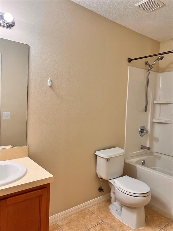 2476 Hassonite Street Kissimmee, FL 34744 - Photo 7 of 8 a bathroom with a sink a toilet and shower