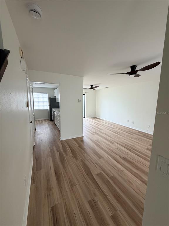 2651 Graduate Court Orlando, FL 32826 - Photo 2 of 13 a view of empty room with wooden floor