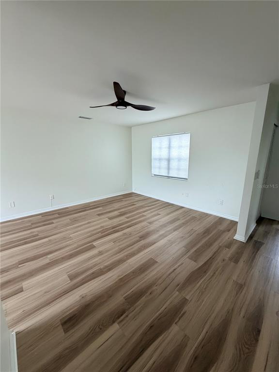 2651 Graduate Court Orlando, FL 32826 - Photo 5 of 13 a view of empty room with wooden floor