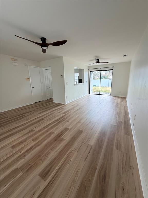 2651 Graduate Court Orlando, FL 32826 - Photo 8 of 13 wooden floor in an empty room with a window