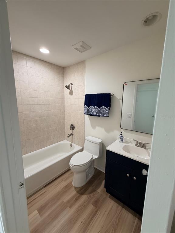 2651 Graduate Court Orlando, FL 32826 - Photo 10 of 13 a spacious bathroom with a double vanity sink a toilet a bathtub and mirror