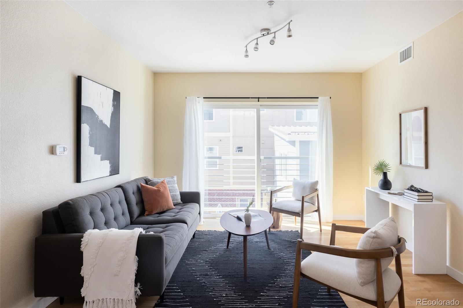 2999 Lawrence Street, Unit 202 Denver, CO 80205 - Photo 11 of 40 a living room with furniture and a large window