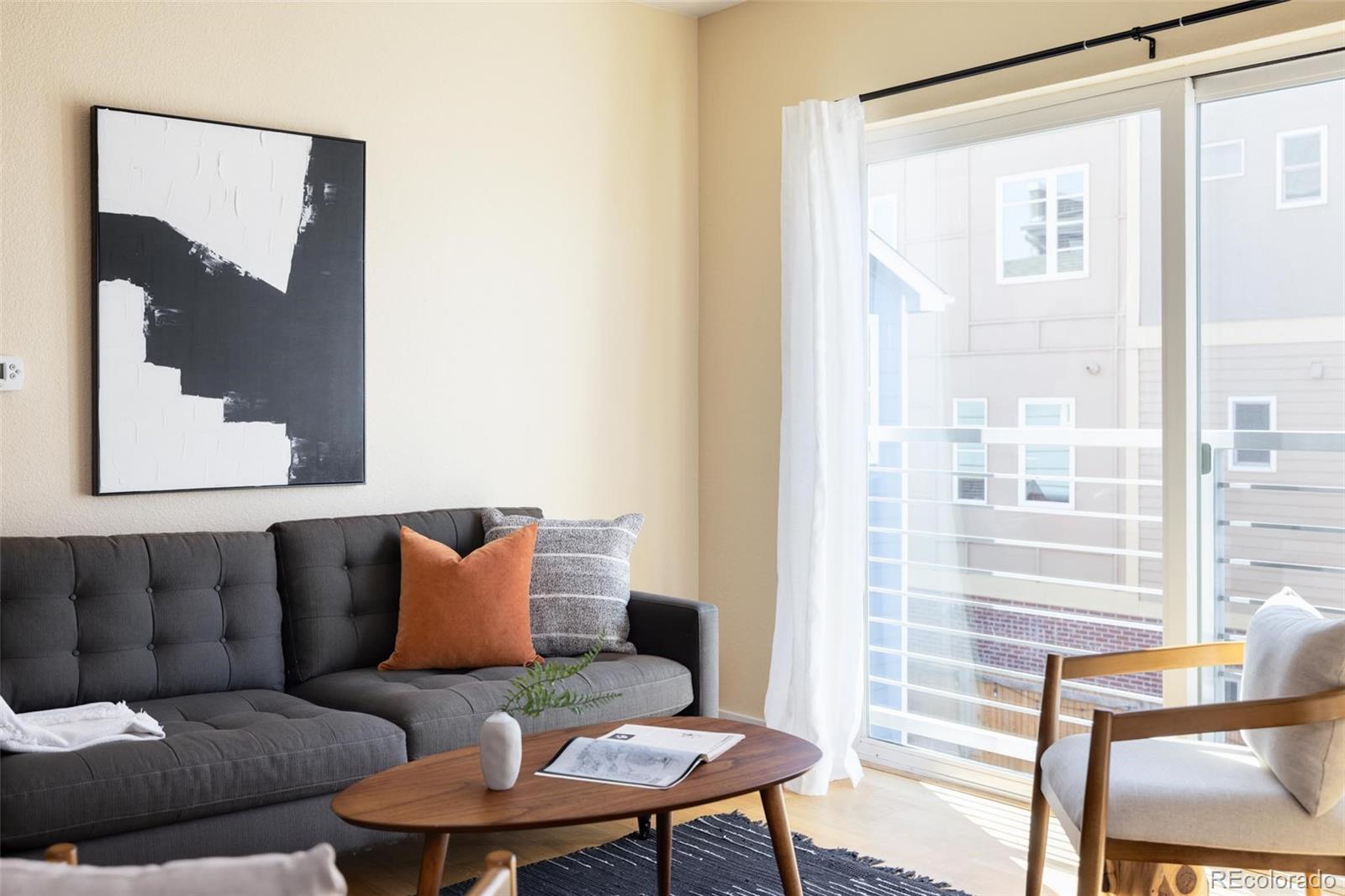 2999 Lawrence Street, Unit 202 Denver, CO 80205 - Photo 12 of 40 a living room with furniture and a large window