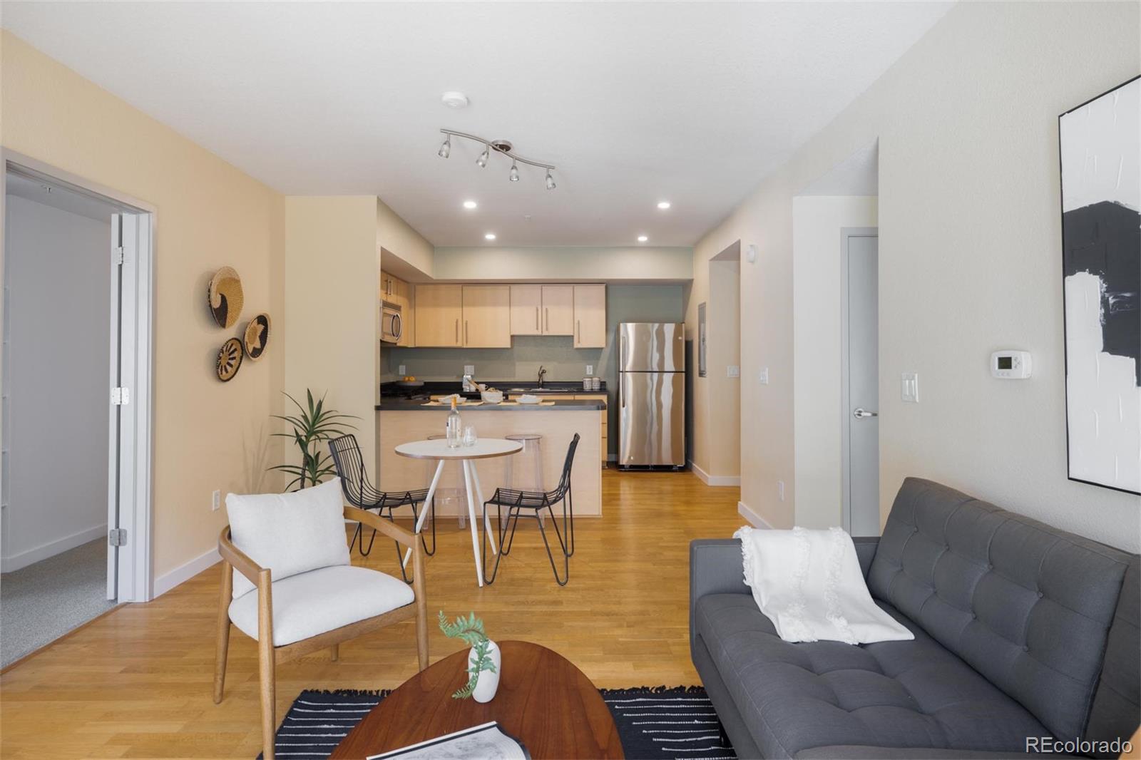 2999 Lawrence Street, Unit 202 Denver, CO 80205 - Photo 13 of 40 a living room with furniture and kitchen view