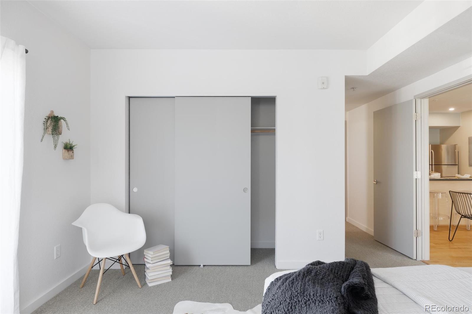 2999 Lawrence Street, Unit 202 Denver, CO 80205 - Photo 18 of 40 a bedroom with a bed and a lamp