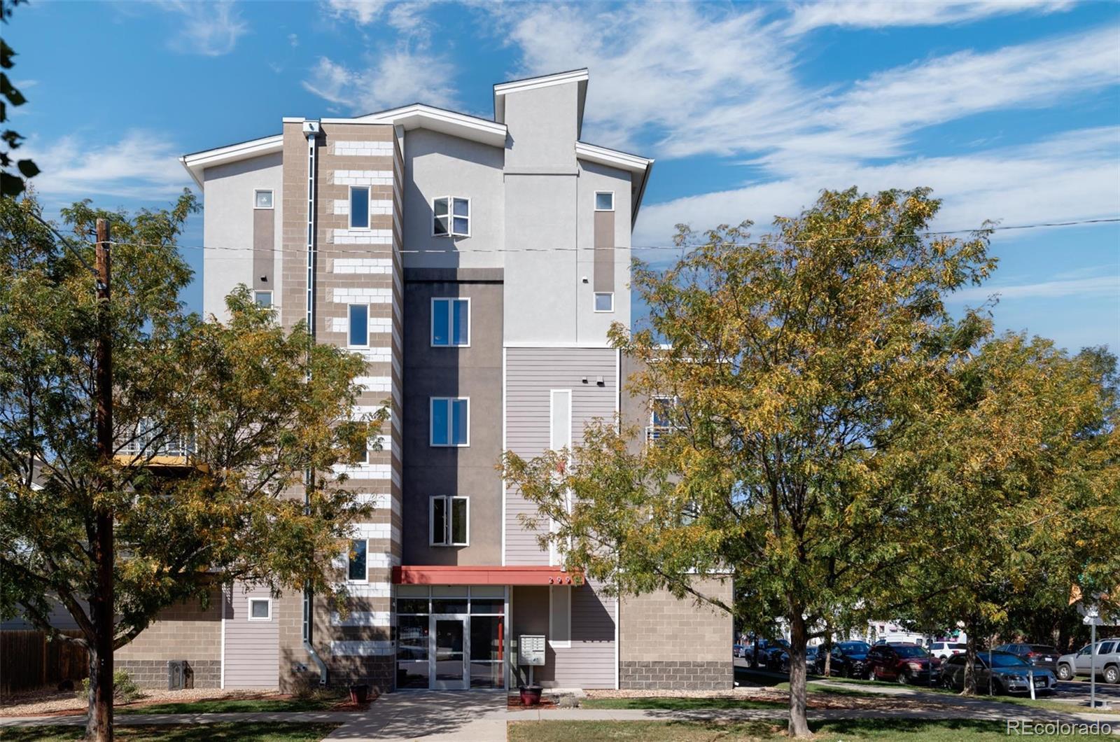 2999 Lawrence Street, Unit 202 Denver, CO 80205 - Photo 2 of 40 a front view of a building with trees