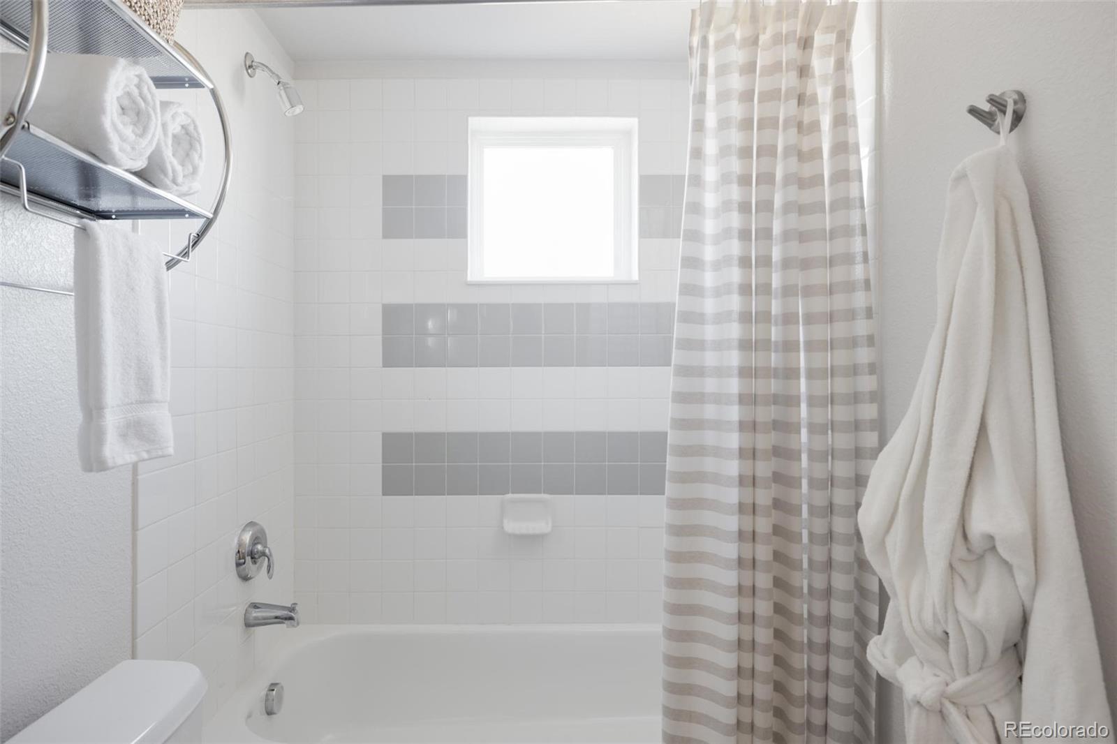 2999 Lawrence Street, Unit 202 Denver, CO 80205 - Photo 21 of 40 a bathroom with a toilet and a shower