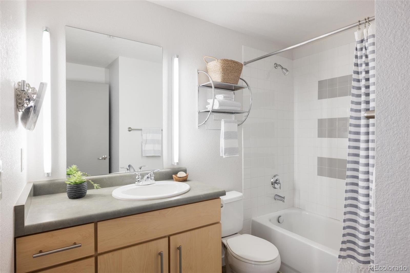 2999 Lawrence Street, Unit 202 Denver, CO 80205 - Photo 25 of 40 a bathroom with a sink a toilet and shower