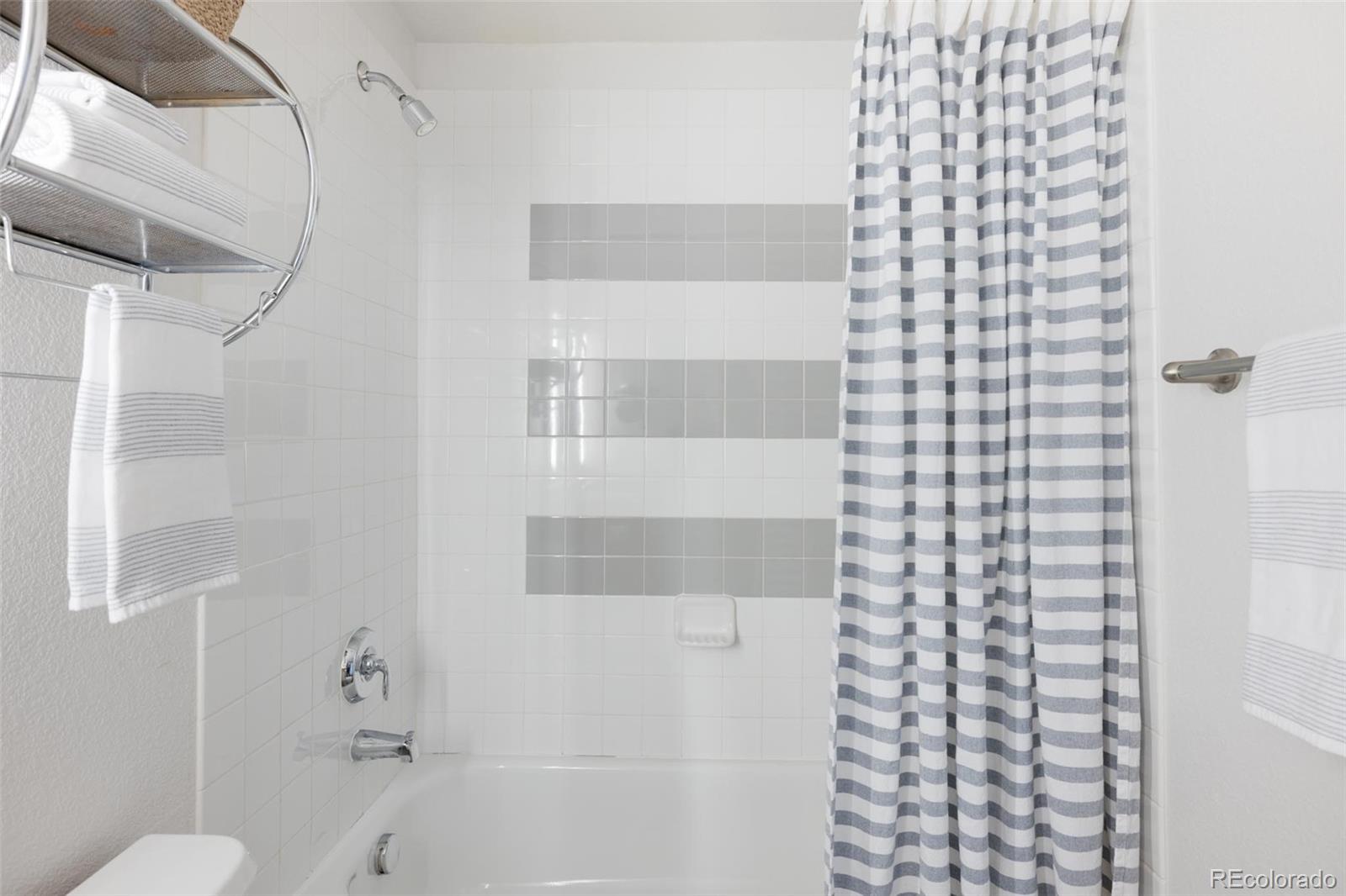 2999 Lawrence Street, Unit 202 Denver, CO 80205 - Photo 26 of 40 a bathroom with a bathtub and shower