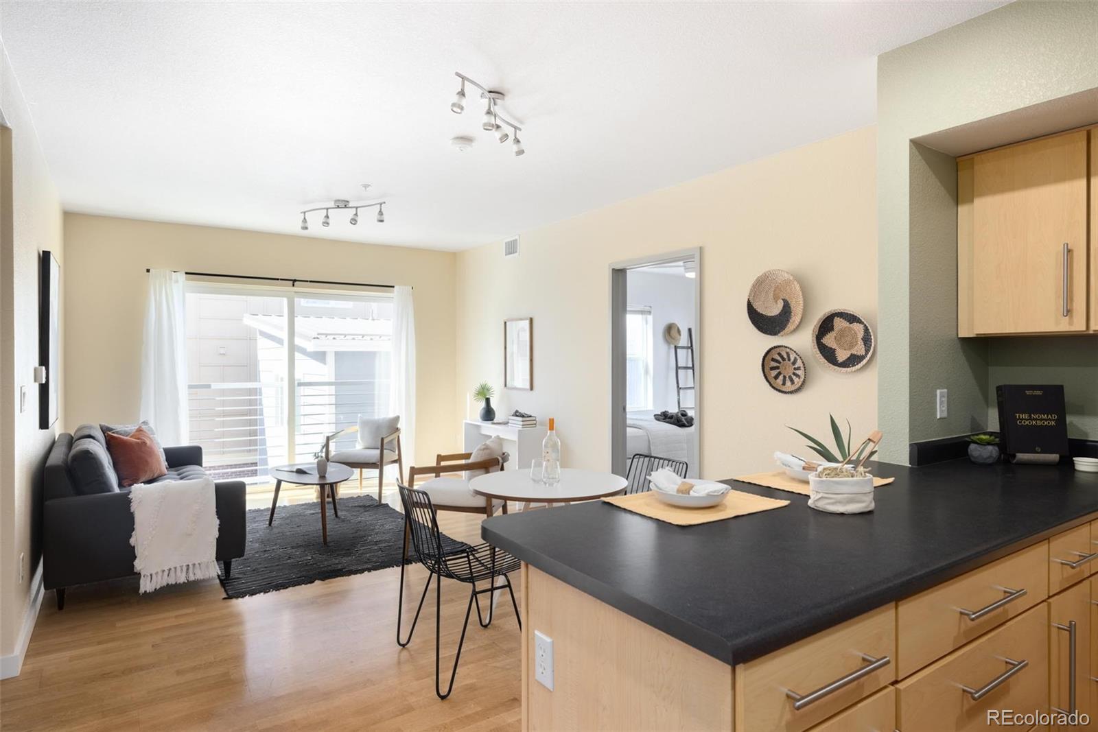 2999 Lawrence Street, Unit 202 Denver, CO 80205 - Photo 5 of 40 a view of a dining room with furniture and wooden floor