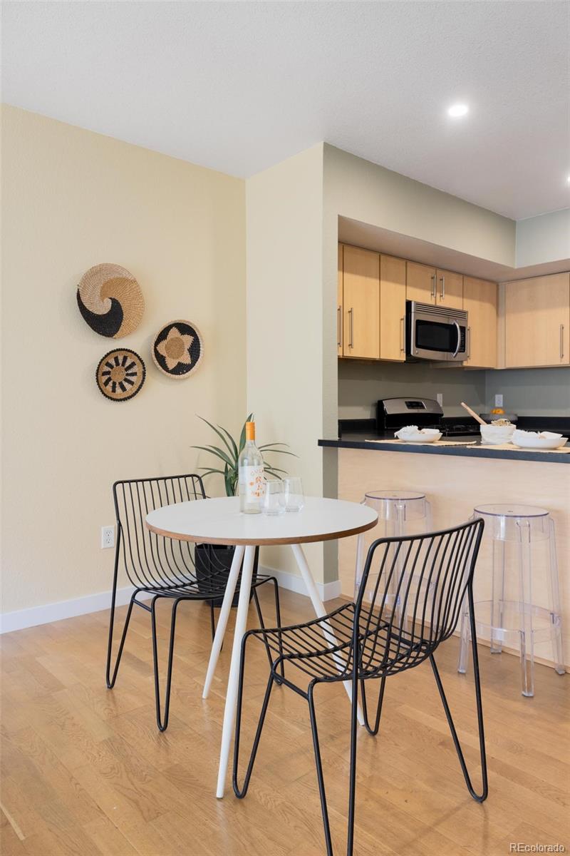 2999 Lawrence Street, Unit 202 Denver, CO 80205 - Photo 9 of 40 a kitchen with a table and chairs in it