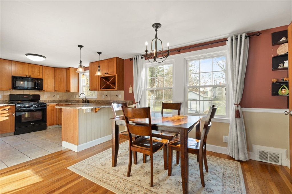 11 Hoover Road Walpole, MA 02081 - Photo 14 of 39 a view of a dining room with furniture window and wooden floor
