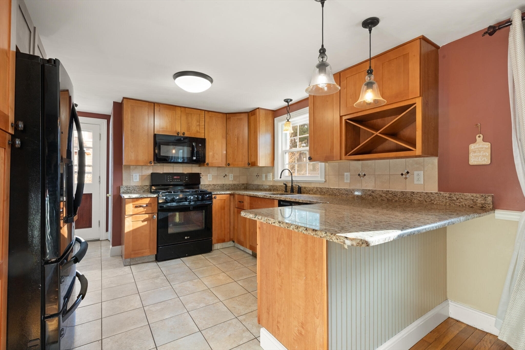 11 Hoover Road Walpole, MA 02081 - Photo 17 of 39 a kitchen with stainless steel appliances granite countertop a sink a stove a refrigerator a washer and dryer