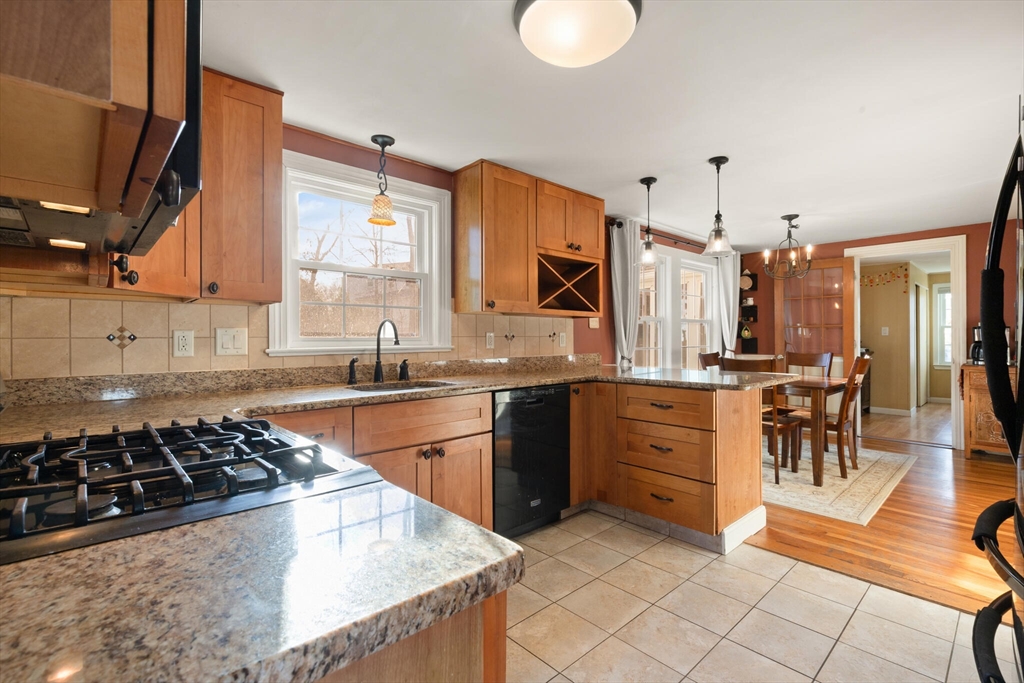 11 Hoover Road Walpole, MA 02081 - Photo 19 of 39 a kitchen with stainless steel appliances a stove a sink cabinets and a dining table