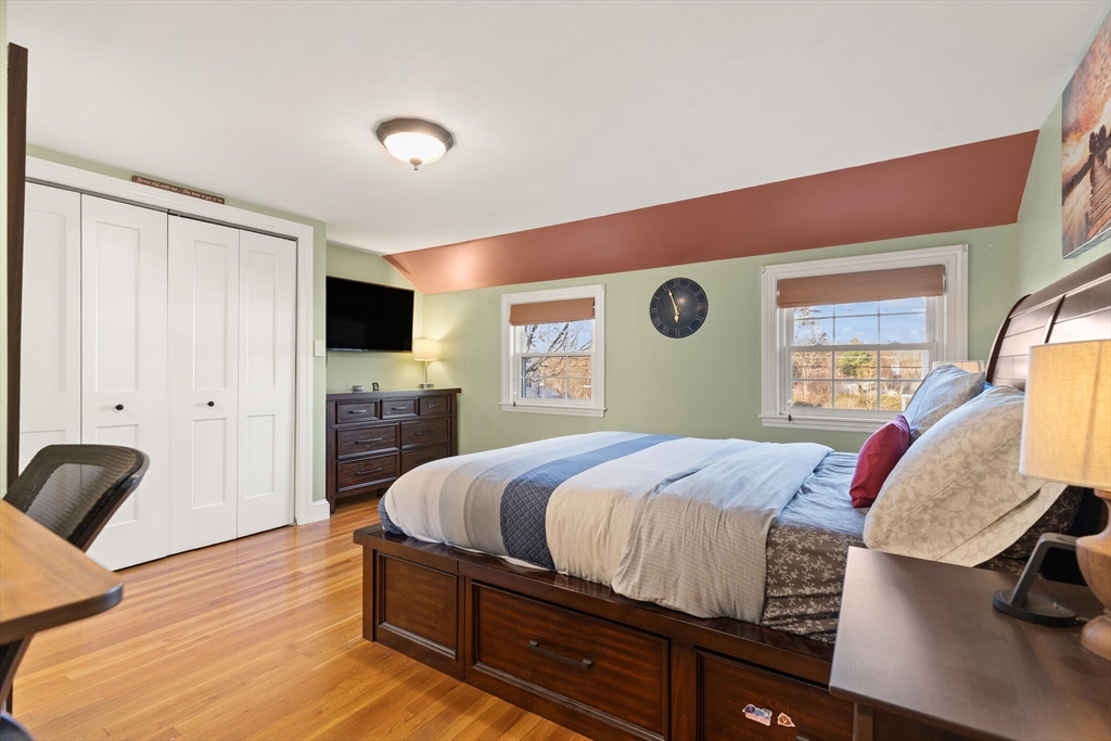 11 Hoover Road Walpole, MA 02081 - Photo 23 of 39 a bedroom with a bed and wooden floor
