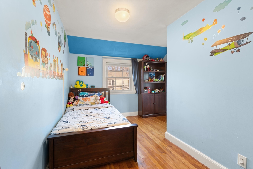 11 Hoover Road Walpole, MA 02081 - Photo 25 of 39 a bedroom with a bed and wooden floor
