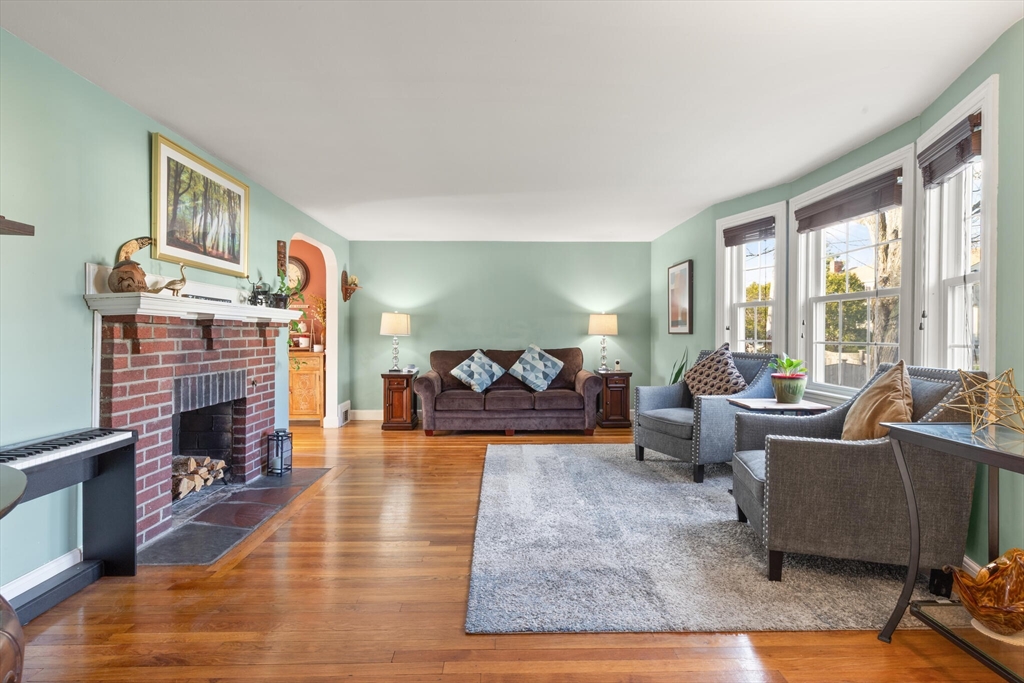 11 Hoover Road Walpole, MA 02081 - Photo 8 of 39 a living room with fireplace furniture and a large window
