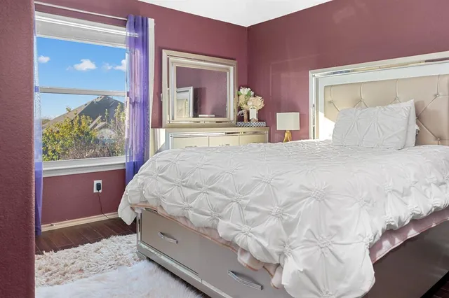 a bed sitting in a bedroom next to a window