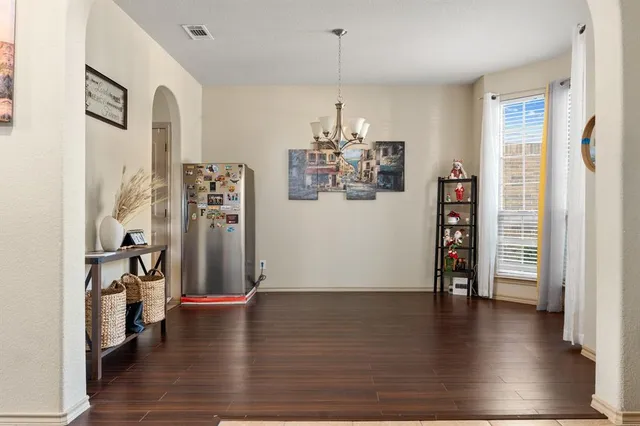 a view of a kitchen with a sink and refrigerator