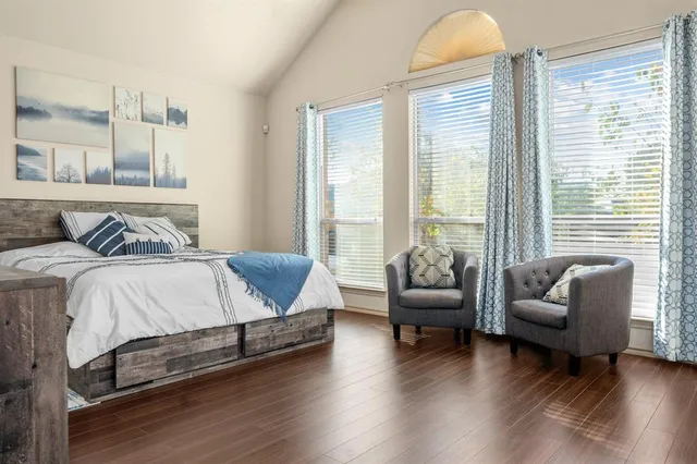 a bedroom with furniture and wooden floor