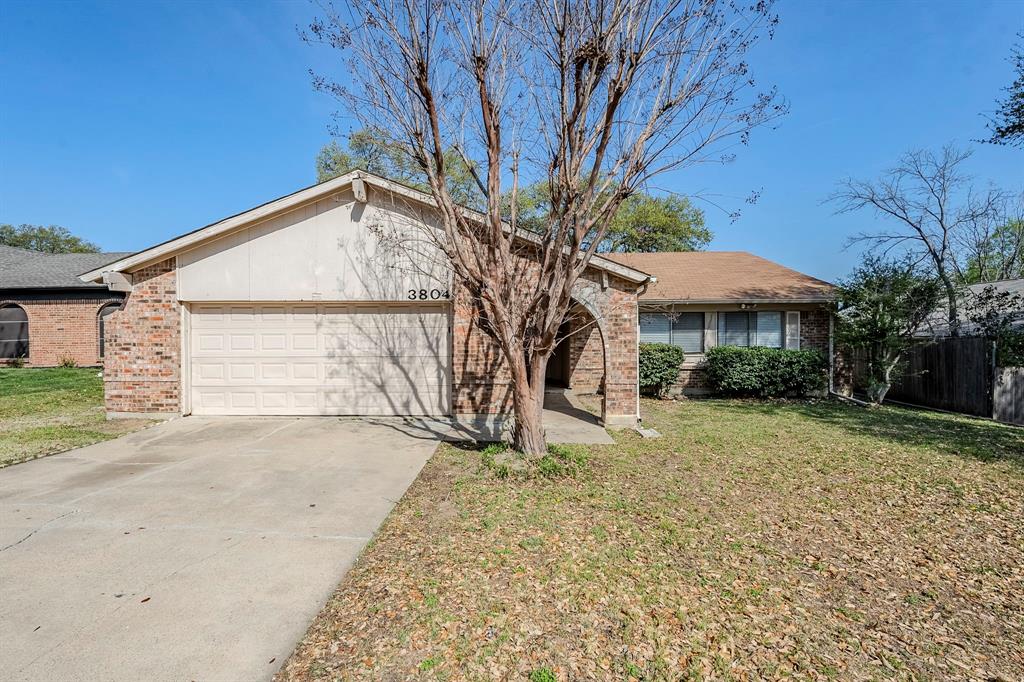 3804 Sugar Ridge Road Fort Worth, TX 76133 - Photo 1 of 1 View of front facade with fence, a garage, concrete driveway, a front yard, and brick siding