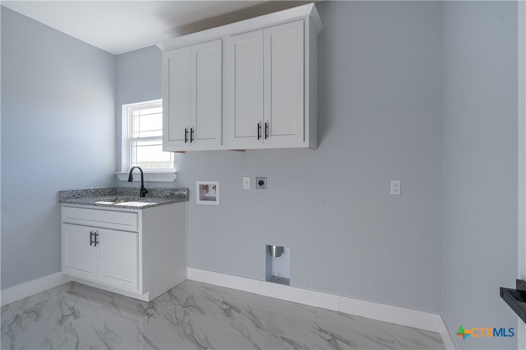 1000 Black Ankle Road Lockhart, TX 78644 - Photo 23 of 40 a room with white cabinets and sink