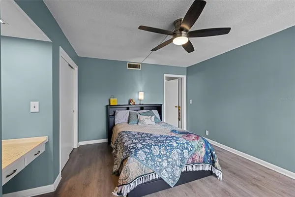 a bedroom with a bed dresser and a window